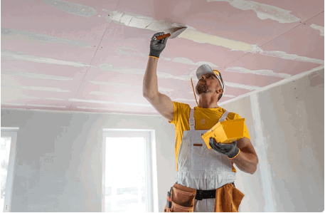drywall-ceiling-finishing.png Drywall contractor applying a smooth finish to a ceiling surface.