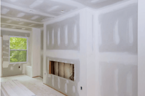 living-room-drywall-finishing.png Living room with freshly finished drywall prepared for interior painting.